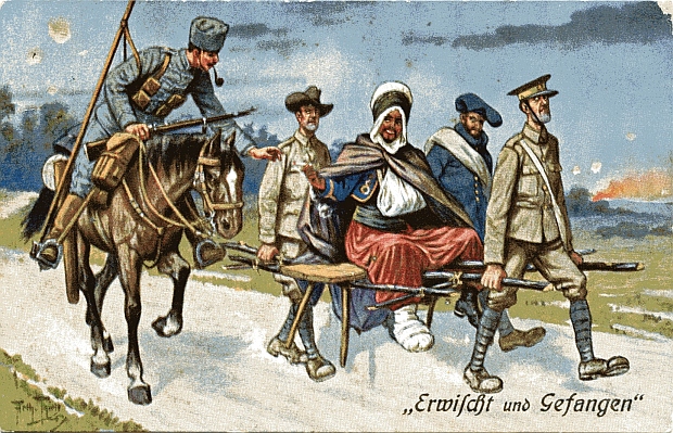 "Erwischt und Gefangen". Ansichtskarte (sign. Arthur Thiele), gelaufen als Feldpost im Mai 1916 (Reserve-Pionier-Kompagnie 53). Sammlung Markus Kreis. Eine Ansichtskarte, die die chauvinistische Schadenfreude darüber zum Ausdruck bringt, dass die kriegsgefangenen Alliierten einen - ebenfalls gefangenen - nordafrikanischen Soldat auf der Bahre tragen müssen. Der "Spahi" reicht dem deutschen Wachmann (oder erhält von ihm?) eine Zigarette, was in diesem Kontext lediglich als erweiterte "Erniedrigung" der Alliierten verstanden werden kann.
