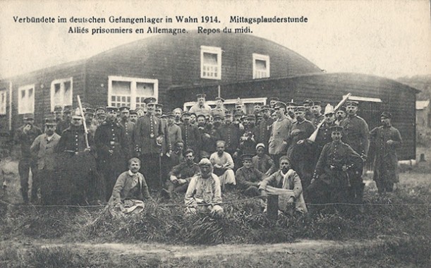 "Verbündete im deutschen Gefangenenlager in Wahn 1914. Mittagsplauderstunde. Alliés prisonniers en Allemagne. Repos du midi". Text Rückseite: "N. Sch. Brux. – Reprod. Interd. – Autor. Par le gouv. Allemand, Brux." Carte Postale, ungelaufen. Sammlung Detlev Brum. Die zweisprachige Version ist vermutlich eine Ansichtskarte, die speziell für Kriegsgefangene angefertigt wurde, die solche Ansichtskarten in die Heimat verschickten.